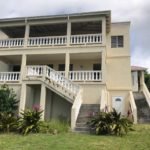 Spacious beachfront property listed by 17 Degrees North Realtors, featuring multiple balconies and stunning ocean views. Perfect for luxury real estate buyers seeking island paradise homes.