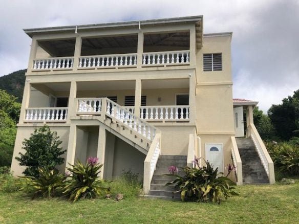 Spacious beachfront property listed by 17 Degrees North Realtors, featuring multiple balconies and stunning ocean views. Perfect for luxury real estate buyers seeking island paradise homes.
