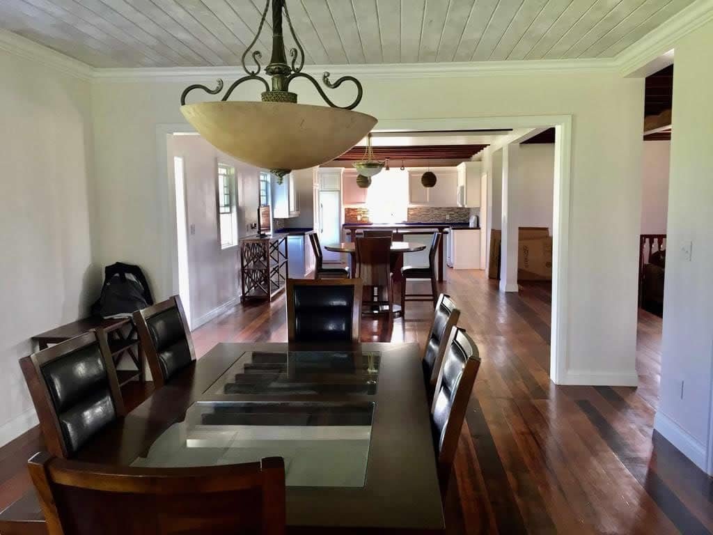 Spacious dining area with hardwood floors, modern lighting, and open-concept design in a North Evis home listed by 17 Degrees North Realtors.