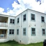 17 Degrees North Realtors property listing in Evis, showcasing a multi-family residential building with multiple windows and a balcony, ideal for investment or rental purposes.
