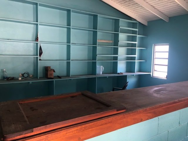 Built-in turquoise bookshelf and workspace area in a modern home office or commercial space near 17 Degrees North Realtors.
