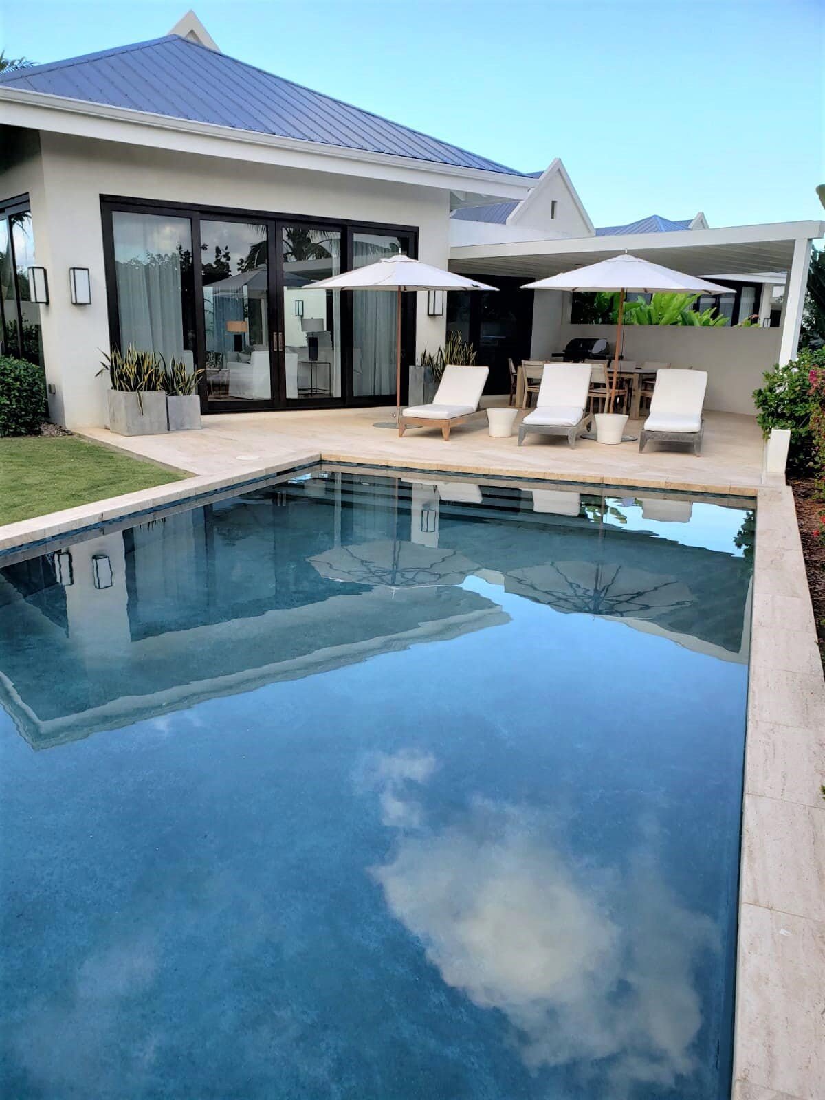 Pic2 Luxurious modern home with private pool, outdoor lounge, and lush landscaping, ideal for relaxing and entertaining in paradise, showcasing premium real estate by 17 Degrees North Realtors.