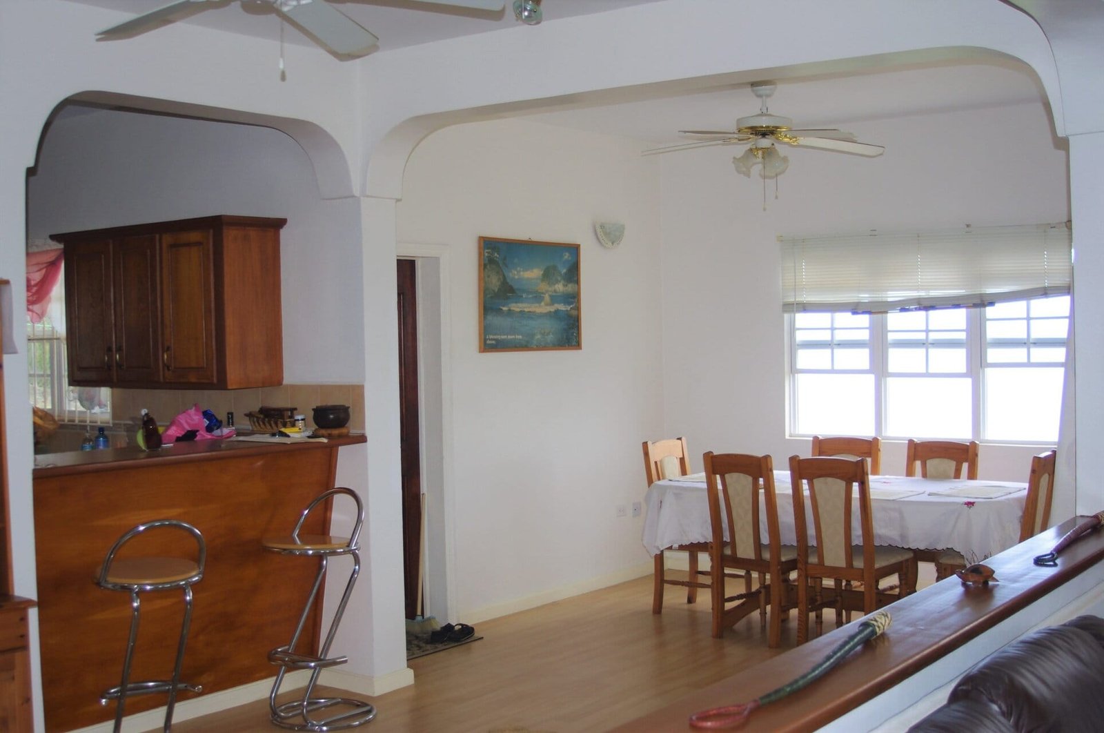 Inside pic 1 Bright dining area in a coastal home with large windows, wooden furniture, and a spacious open-concept kitchen, showcasing real estate listings at 17 Degrees North Realtors in Evist, perfect for beachside living.