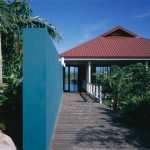 Modern tropical home with lush landscaping and scenic views in Evista, offering luxury real estate in 17 Degrees North community. Perfect for vacation retreats or permanent residence.