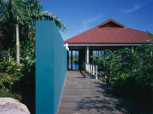 Modern tropical home with lush landscaping and scenic views in Evista, offering luxury real estate in 17 Degrees North community. Perfect for vacation retreats or permanent residence.