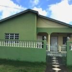 17 Degrees North Realtors property listing exterior shot of green house in Nevis, showcasing prime real estate opportunities.