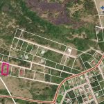Vacant land parcel outlined in pink on a detailed maps of N evis, ideal for building or investment, situated in a serene neighborhood with access to amenities and nature.
