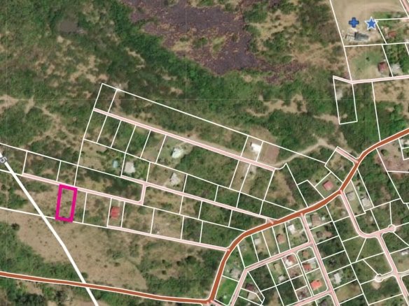 Vacant land parcel outlined in pink on a detailed maps of N evis, ideal for building or investment, situated in a serene neighborhood with access to amenities and nature.