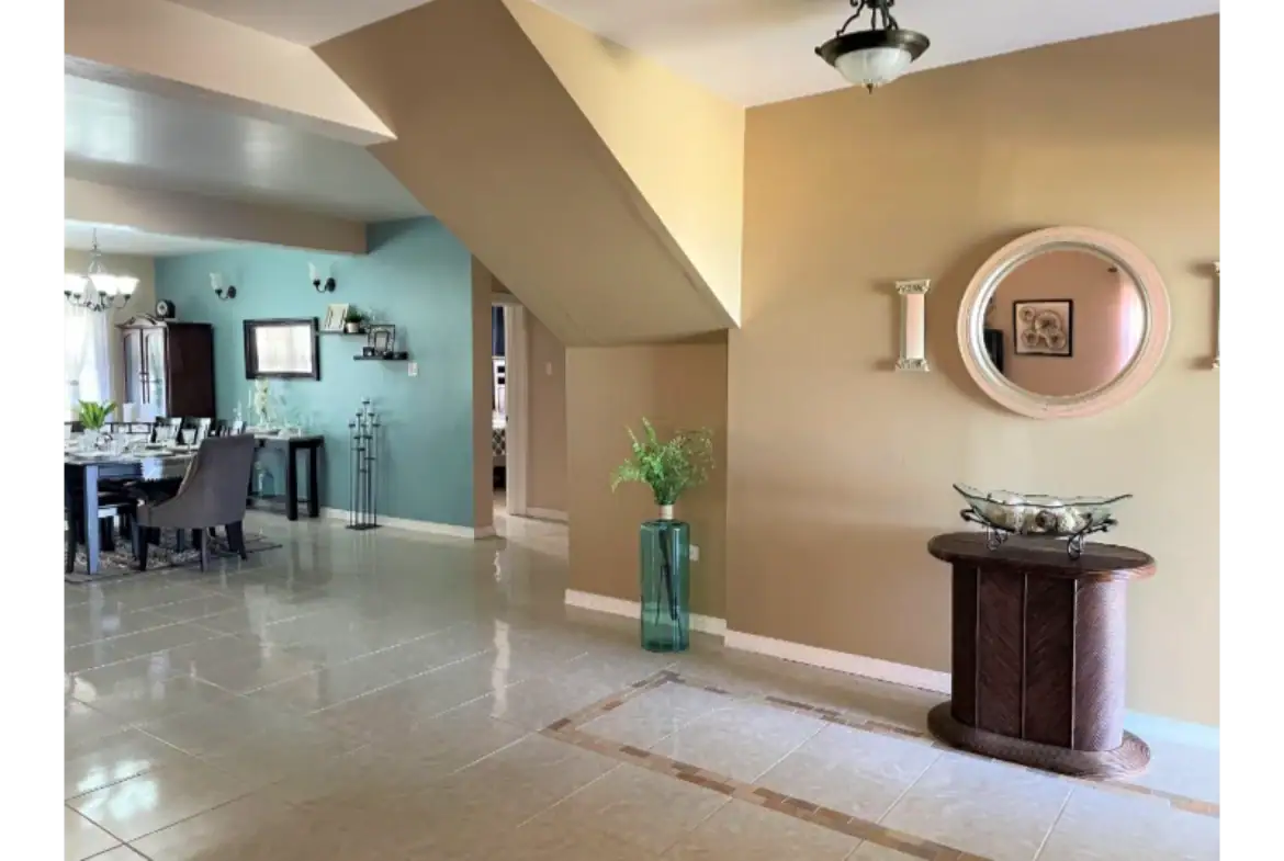 Modern interior living space with elegant decor, featuring a spacious dining area and stylish wall accents, perfect for family living and entertaining.