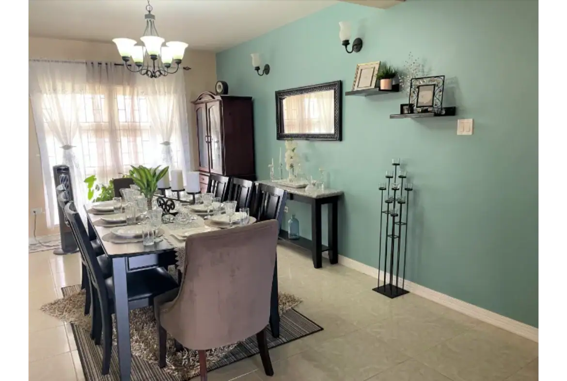 Modern dining room with stylish table decor and elegant lighting, perfect for family meals or entertaining guests in a spacious home.