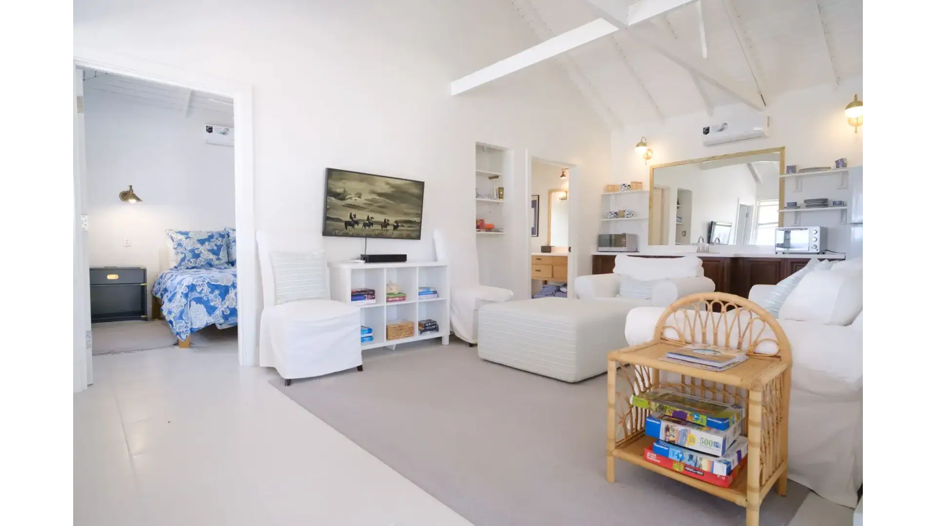 Bright and airy living room in a coastal-style home with white walls, comfortable seating, and modern décor, perfect for relaxing and entertaining in the 17 Degrees North Realtors property.