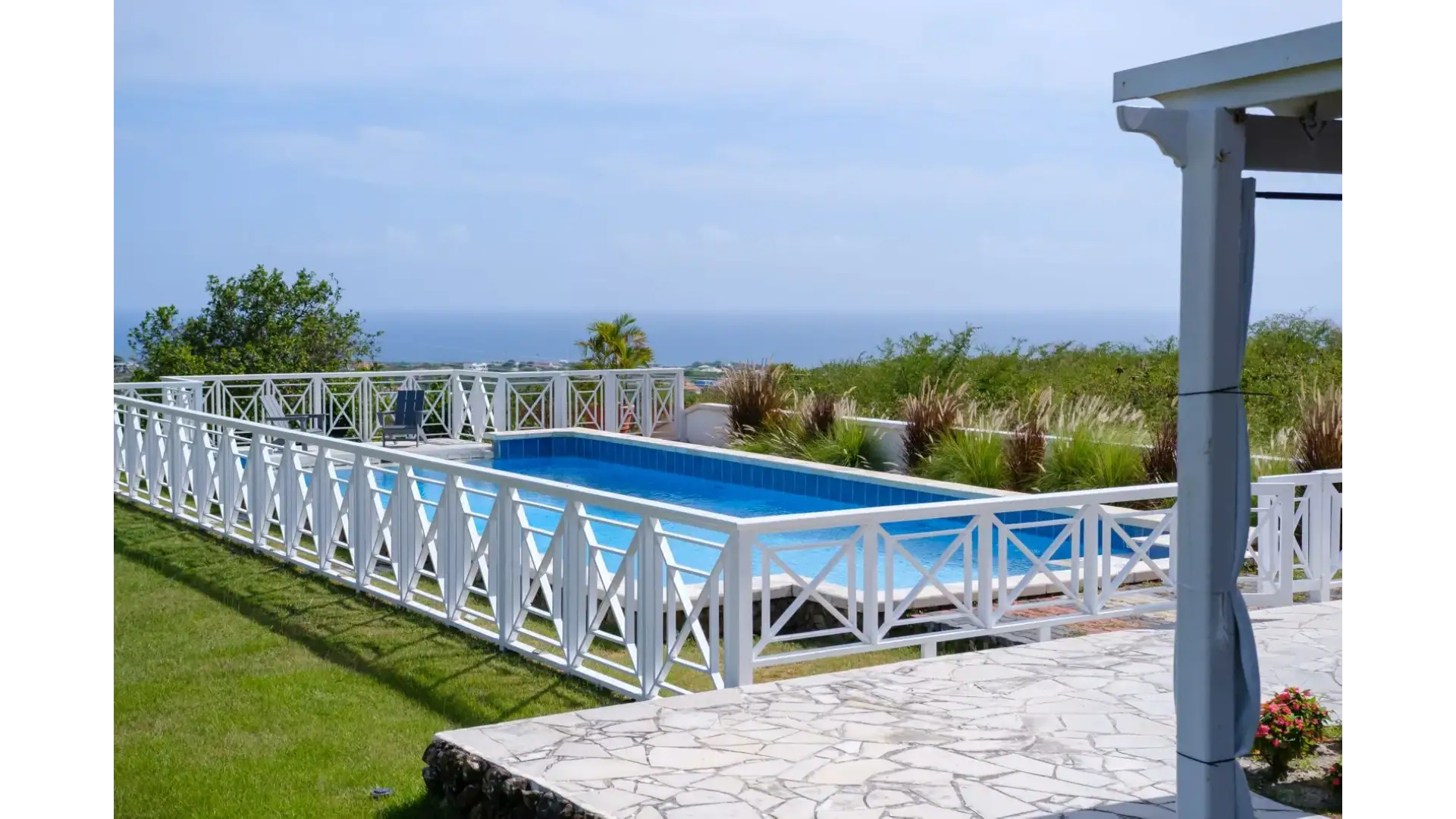 Stunning swimming pool with ocean view at 17 Degrees North Realtors, showcasing luxurious real estate and outdoor living spaces in Evris, perfect for coastal lifestyle and property investment.