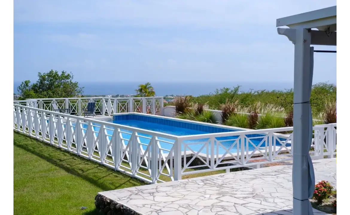 Stunning swimming pool with ocean view at 17 Degrees North Realtors, showcasing luxurious real estate and outdoor living spaces in Nevis, perfect for coastal lifestyle and property investment.