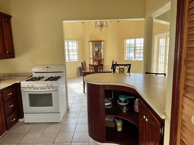 Bright, spacious kitchen with a cozy dining area featuring large windows, wooden cabinets, and modern appliances, ideal for family gatherings and home cooking.